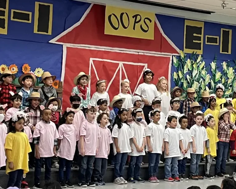 group of kids performing and singing on stage